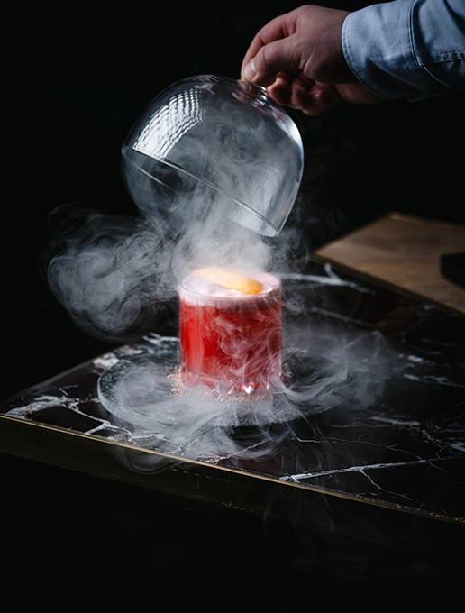Steaming pink cocktail, served at Dans le Noir ? restaurant